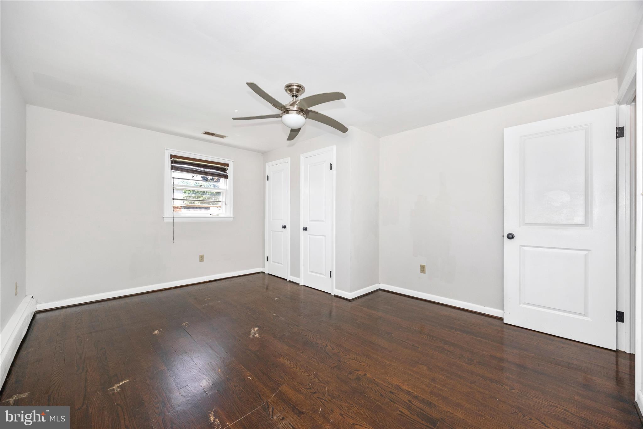 17 East 13th Street Frederick, MD 21701 - Photo 20 of 53 an empty room with wooden floor ceiling fan and windows