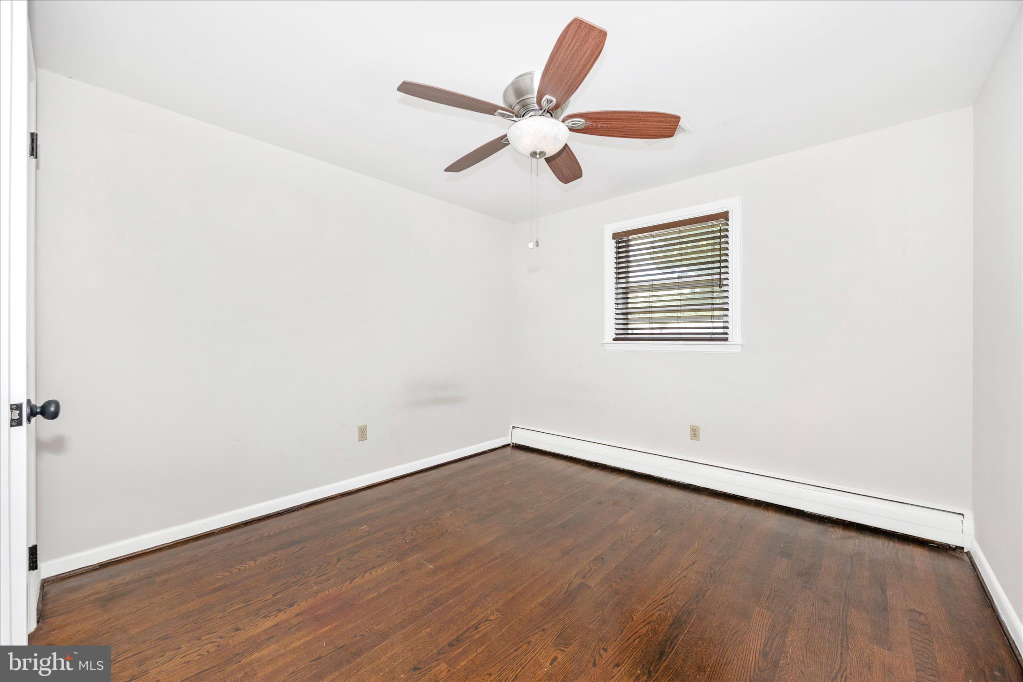 17 East 13th Street Frederick, MD 21701 - Photo 24 of 53 an empty room with wooden floor ceiling fan and window