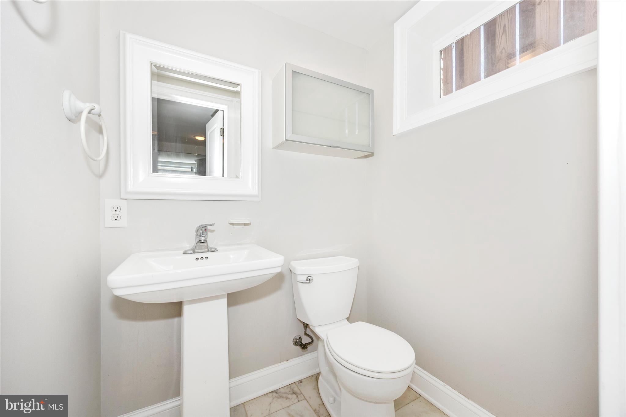 17 East 13th Street Frederick, MD 21701 - Photo 37 of 53 a bathroom with a toilet a sink and mirror