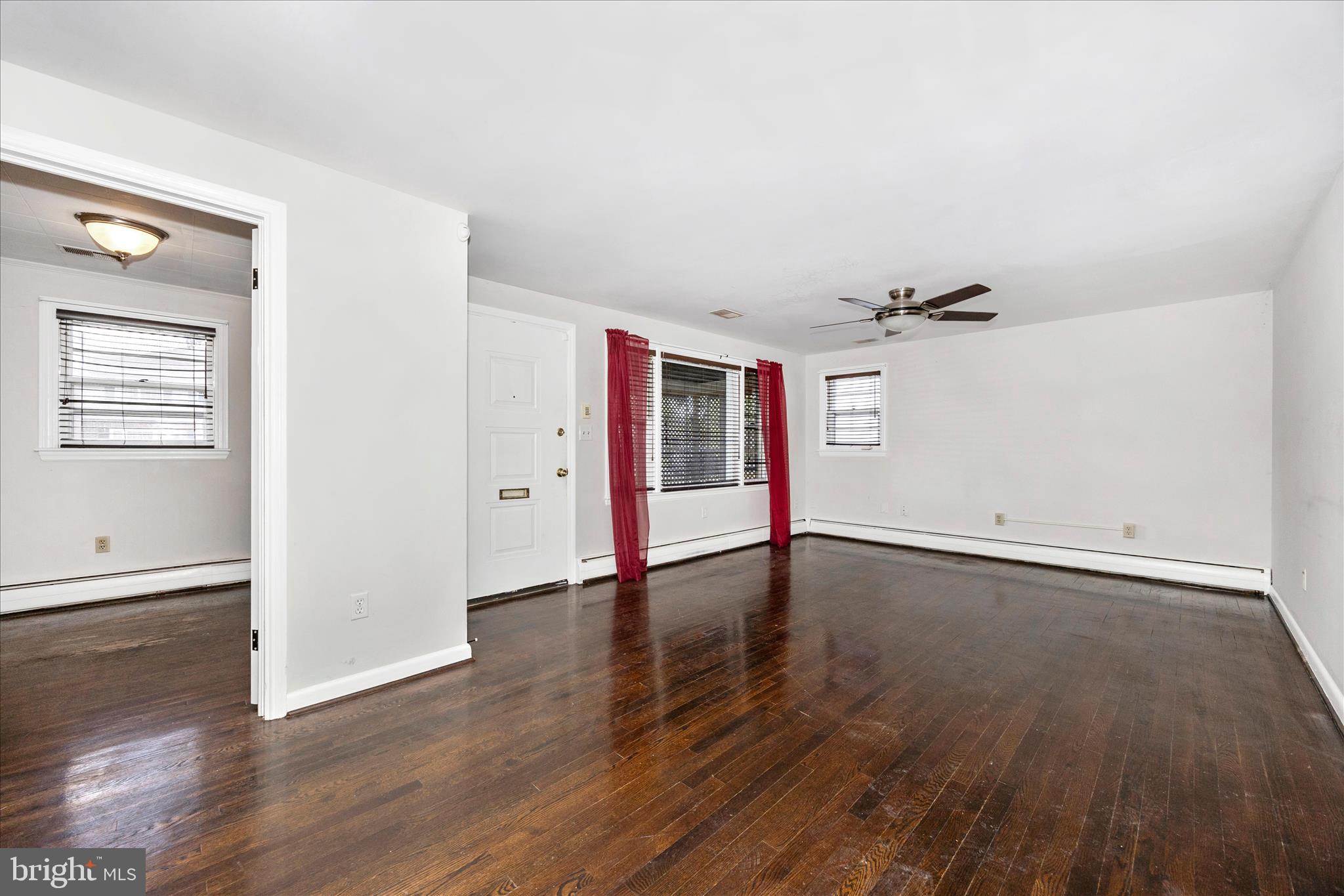 17 East 13th Street Frederick, MD 21701 - Photo 5 of 53 an empty room with wooden floor and windows