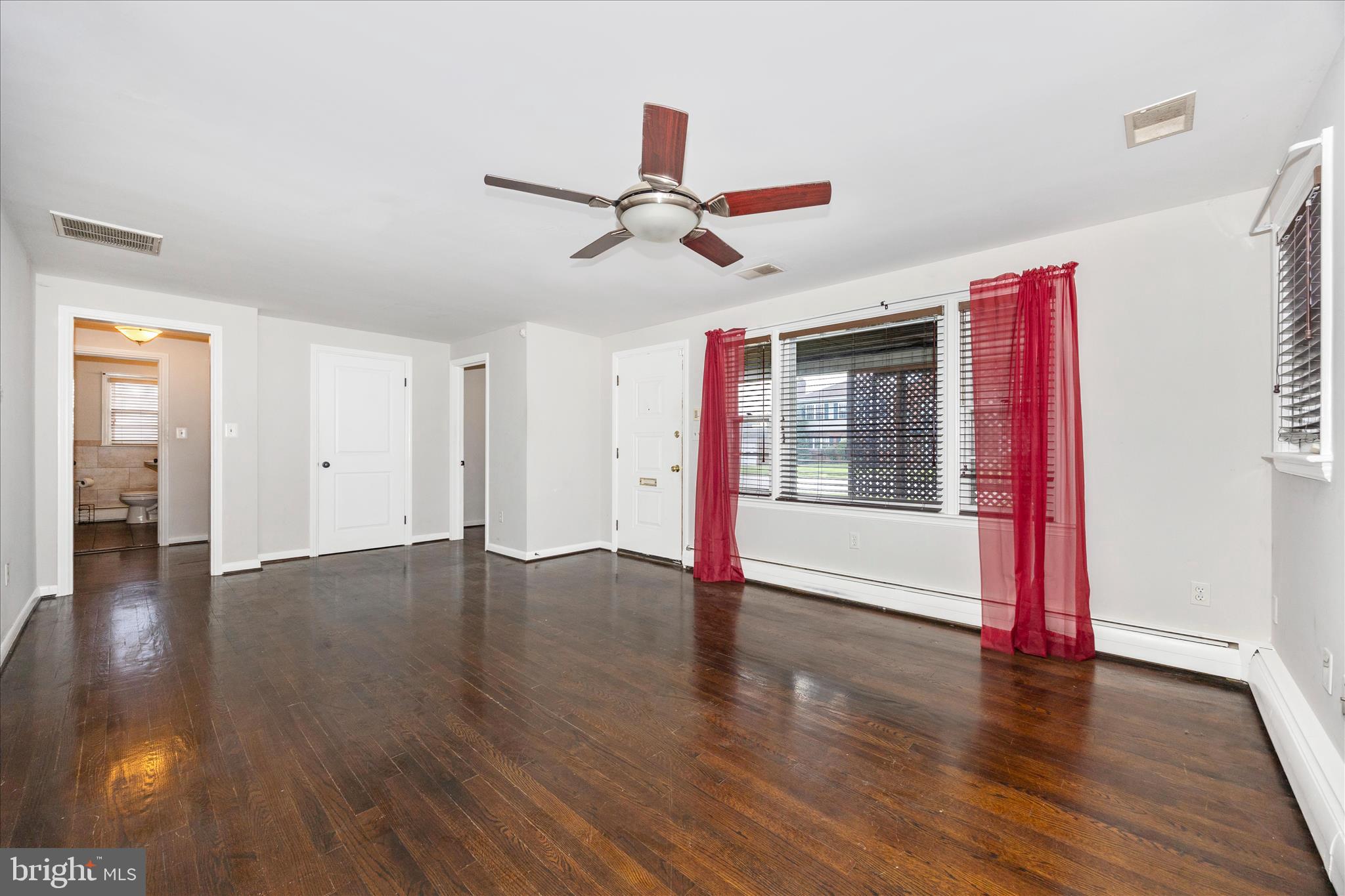 17 East 13th Street Frederick, MD 21701 - Photo 6 of 53 a view of an empty room with wooden floor and a window