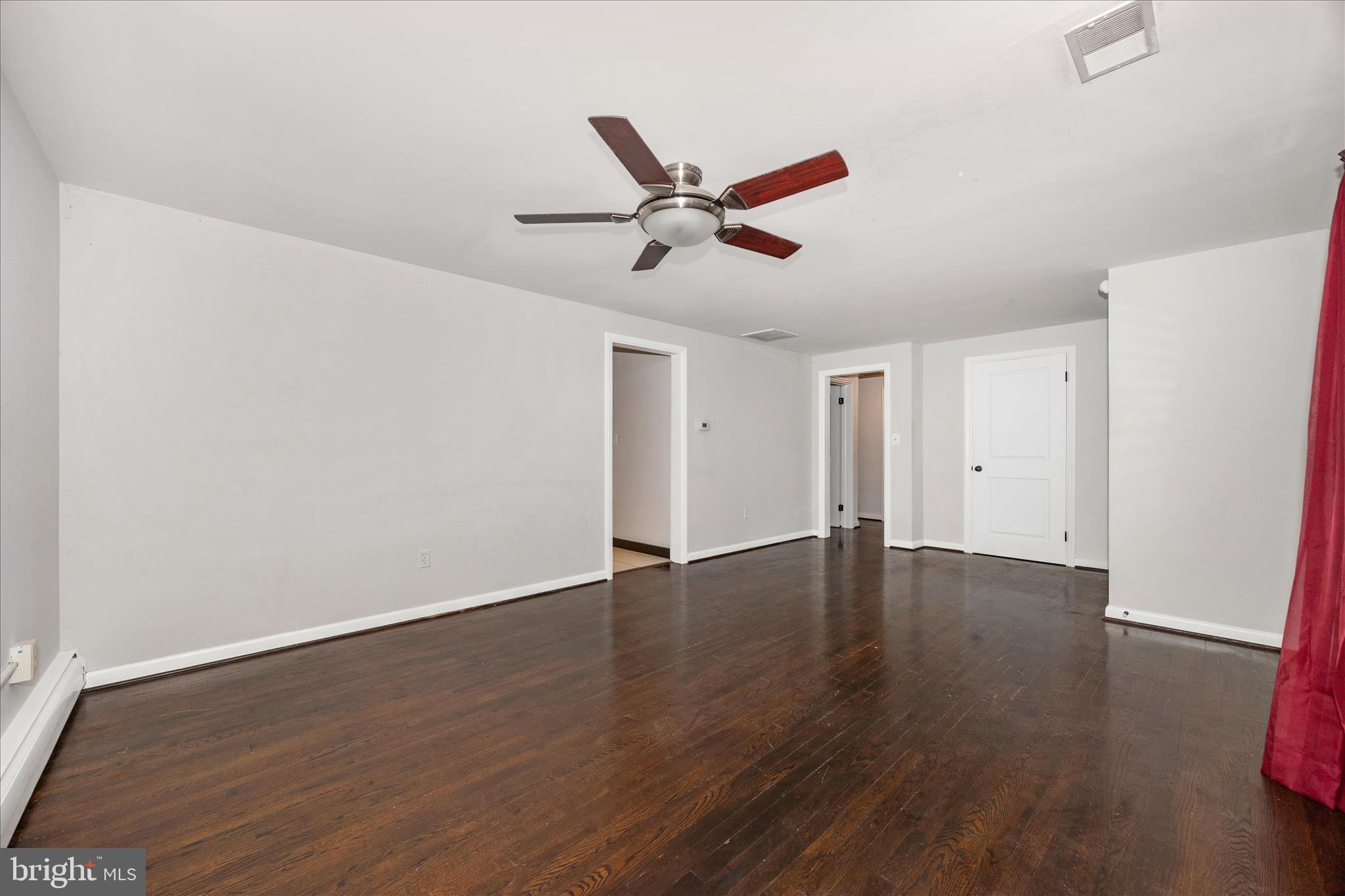 17 East 13th Street Frederick, MD 21701 - Photo 7 of 53 an empty room with wooden floor and ceiling fan
