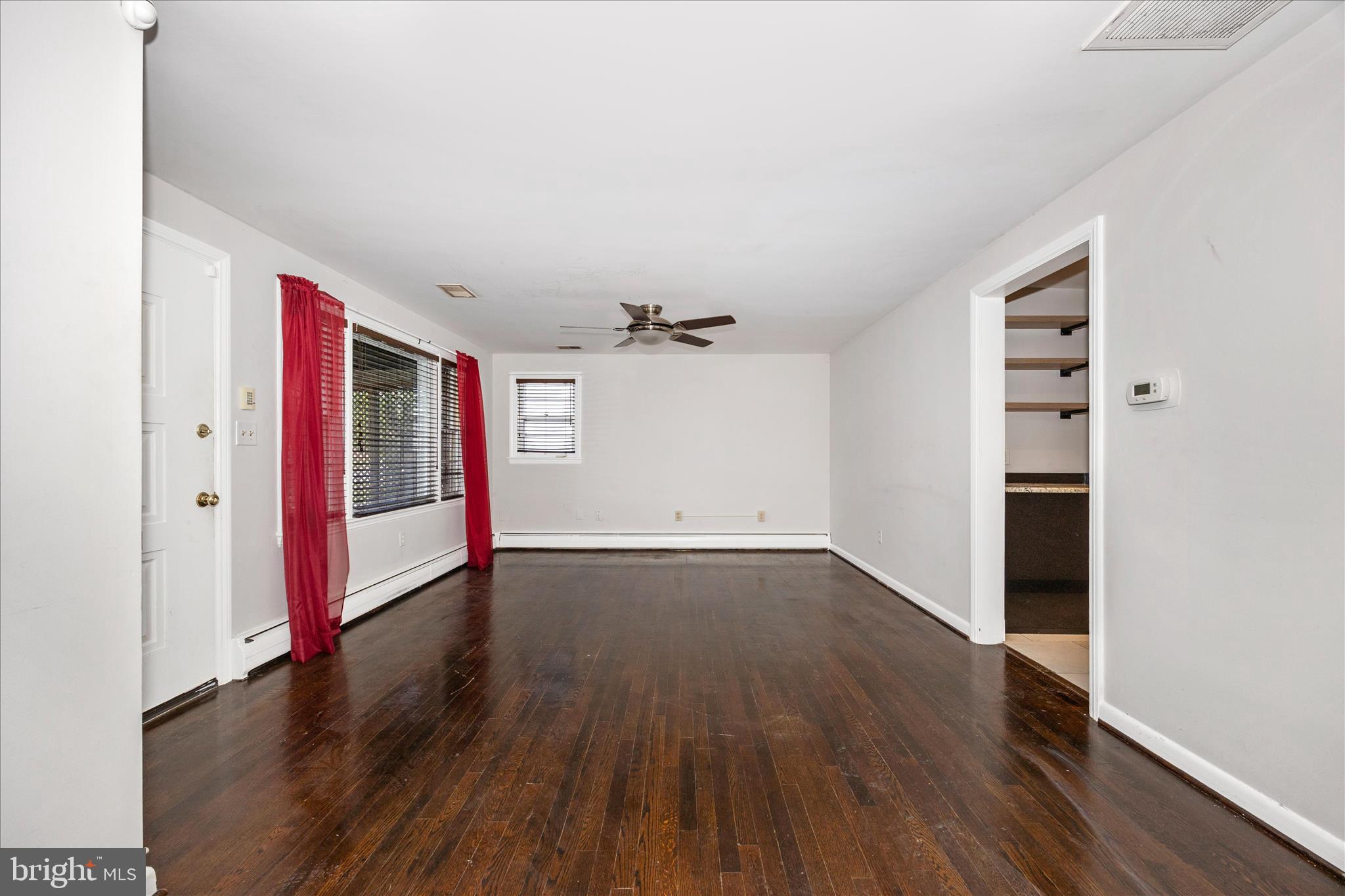 17 East 13th Street Frederick, MD 21701 - Photo 8 of 53 an empty room with wooden floor and windows