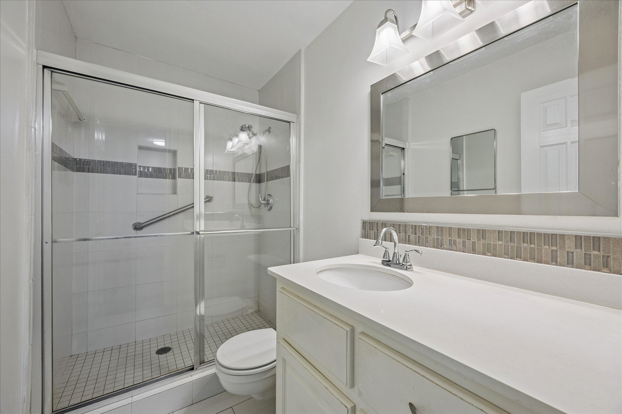 9014 Dunlap Street Houston, TX 77074 - Photo 17 of 23 a bathroom with a sink a toilet and shower