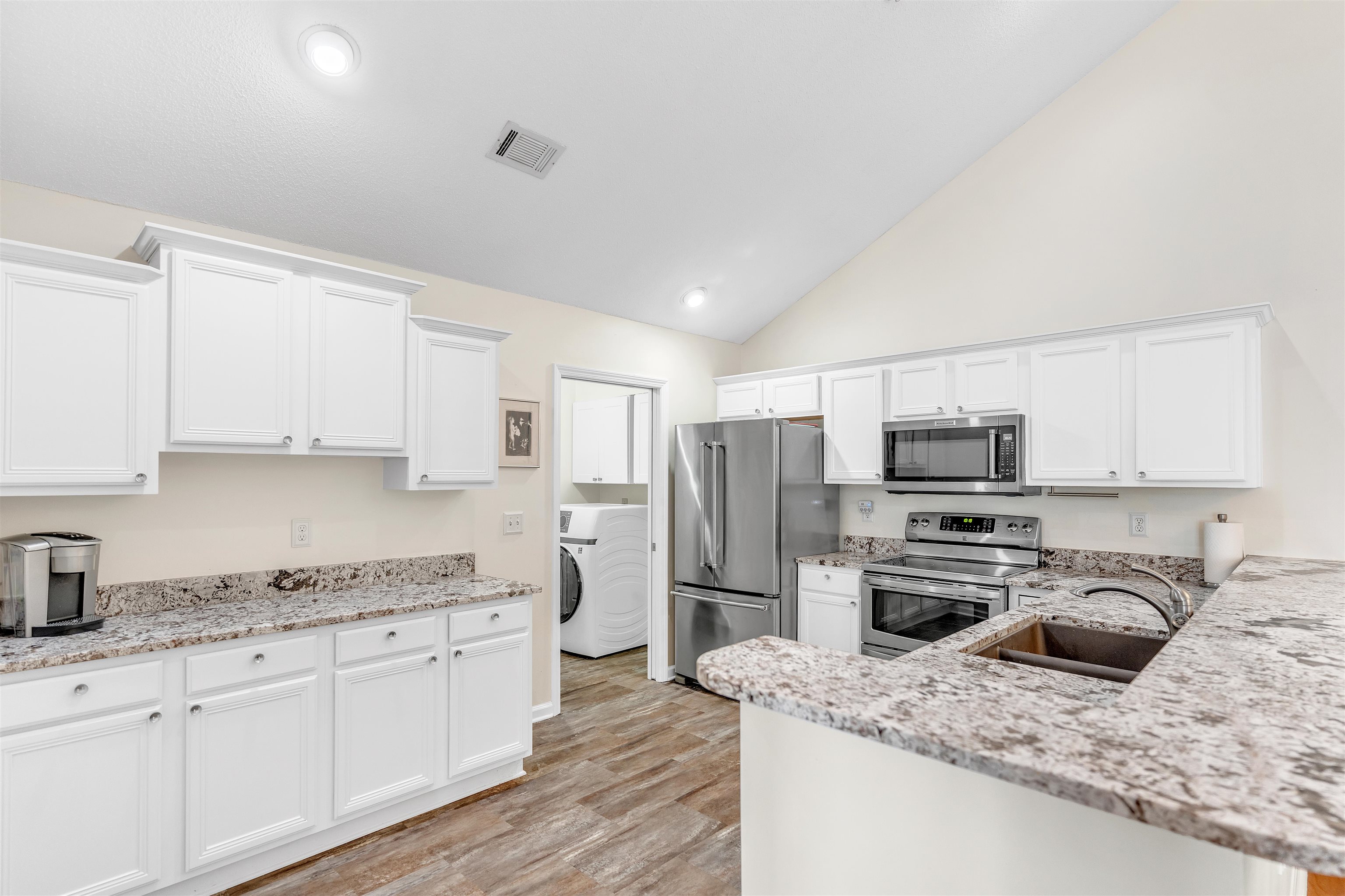 1213 Oak Timber Circle, Unit 25 Collierville, TN 38017 - Photo 11 of 25 Kitchen featuring appliances with stainless steel finishes, a sink, visible vents, and white cabinets