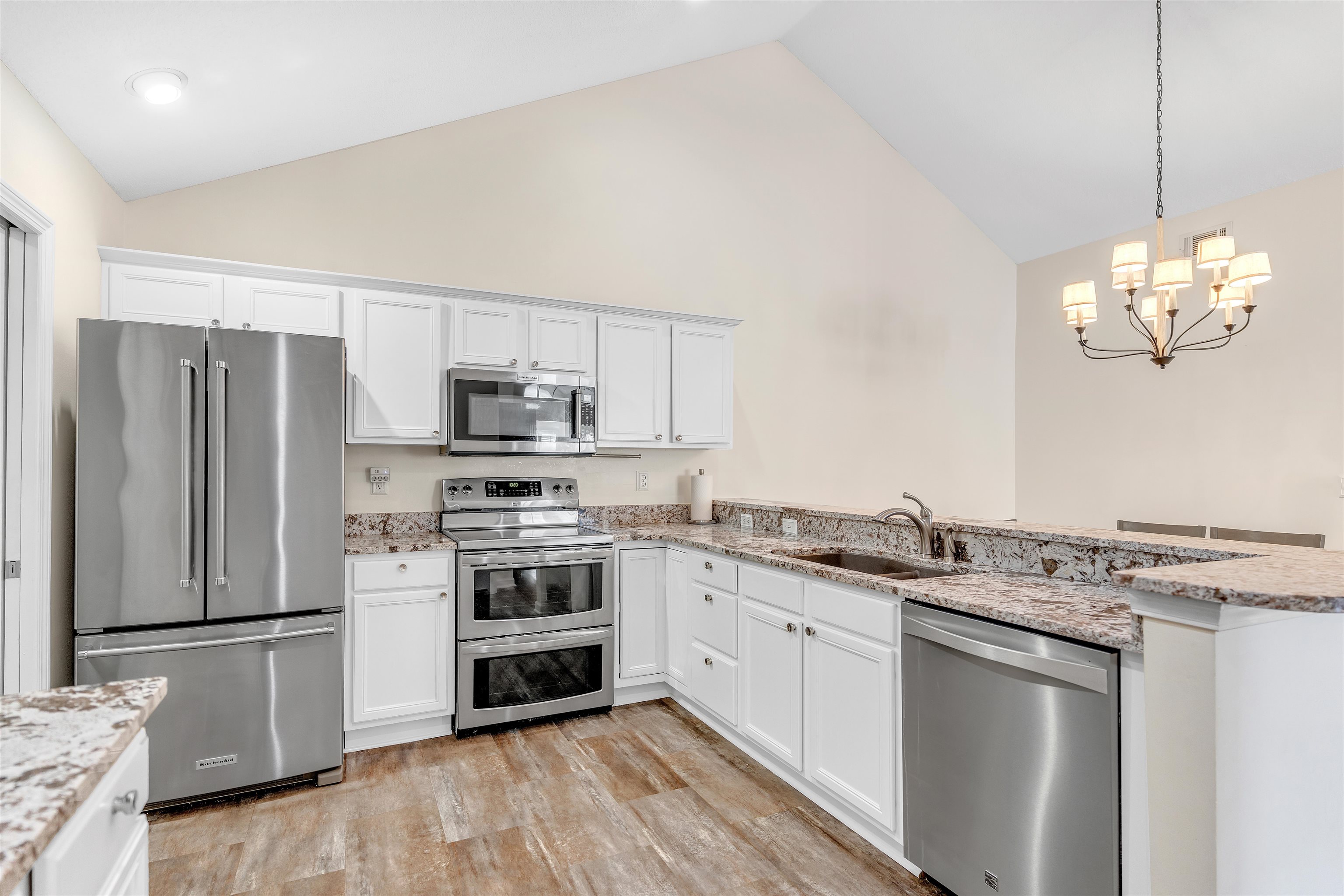 1213 Oak Timber Circle, Unit 25 Collierville, TN 38017 - Photo 12 of 25 Kitchen featuring vaulted ceiling, appliances with stainless steel finishes, white cabinets, and a sink