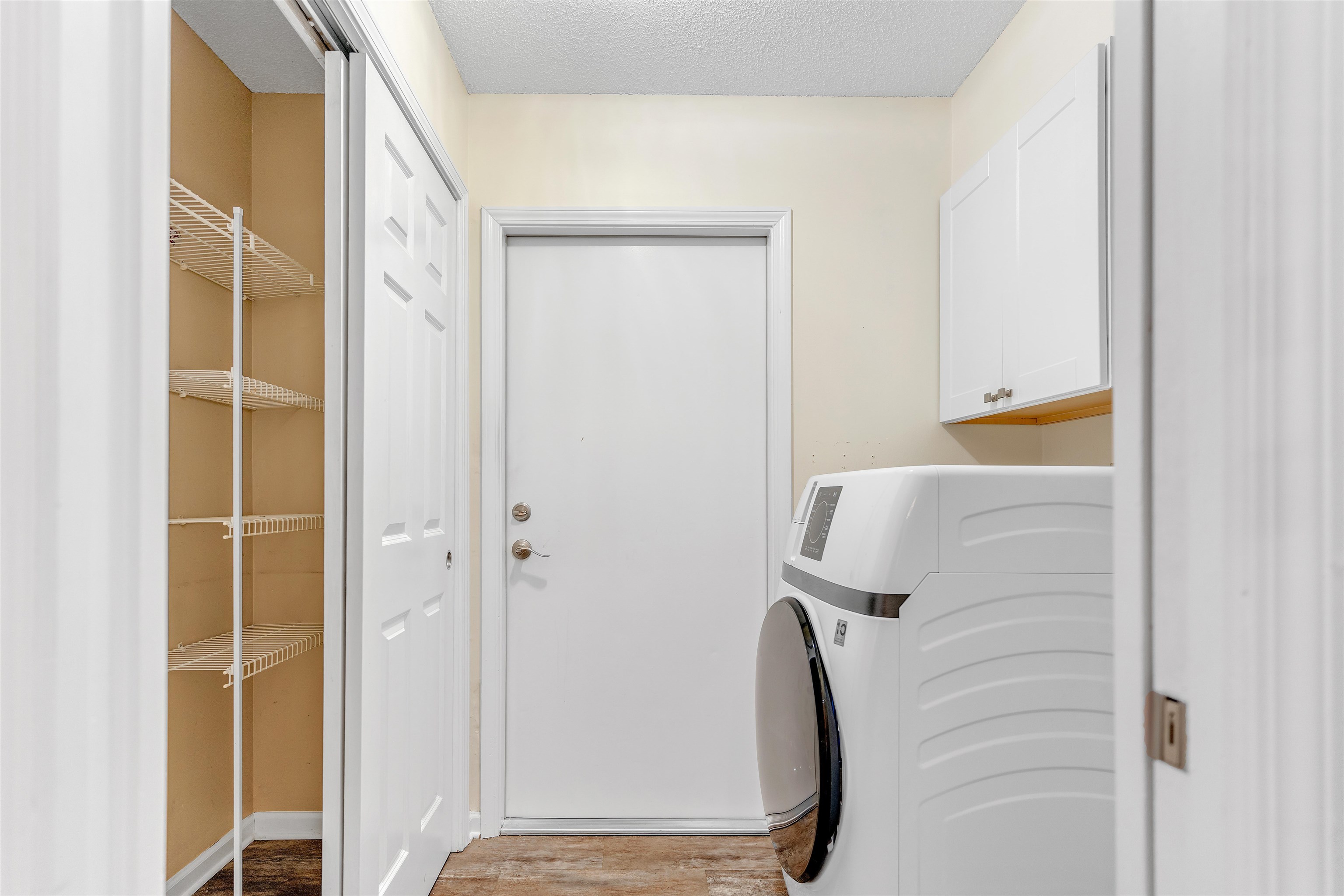 1213 Oak Timber Circle, Unit 25 Collierville, TN 38017 - Photo 13 of 25 Laundry room with cabinet space, light wood finished floors, a textured ceiling, and washer / dryer