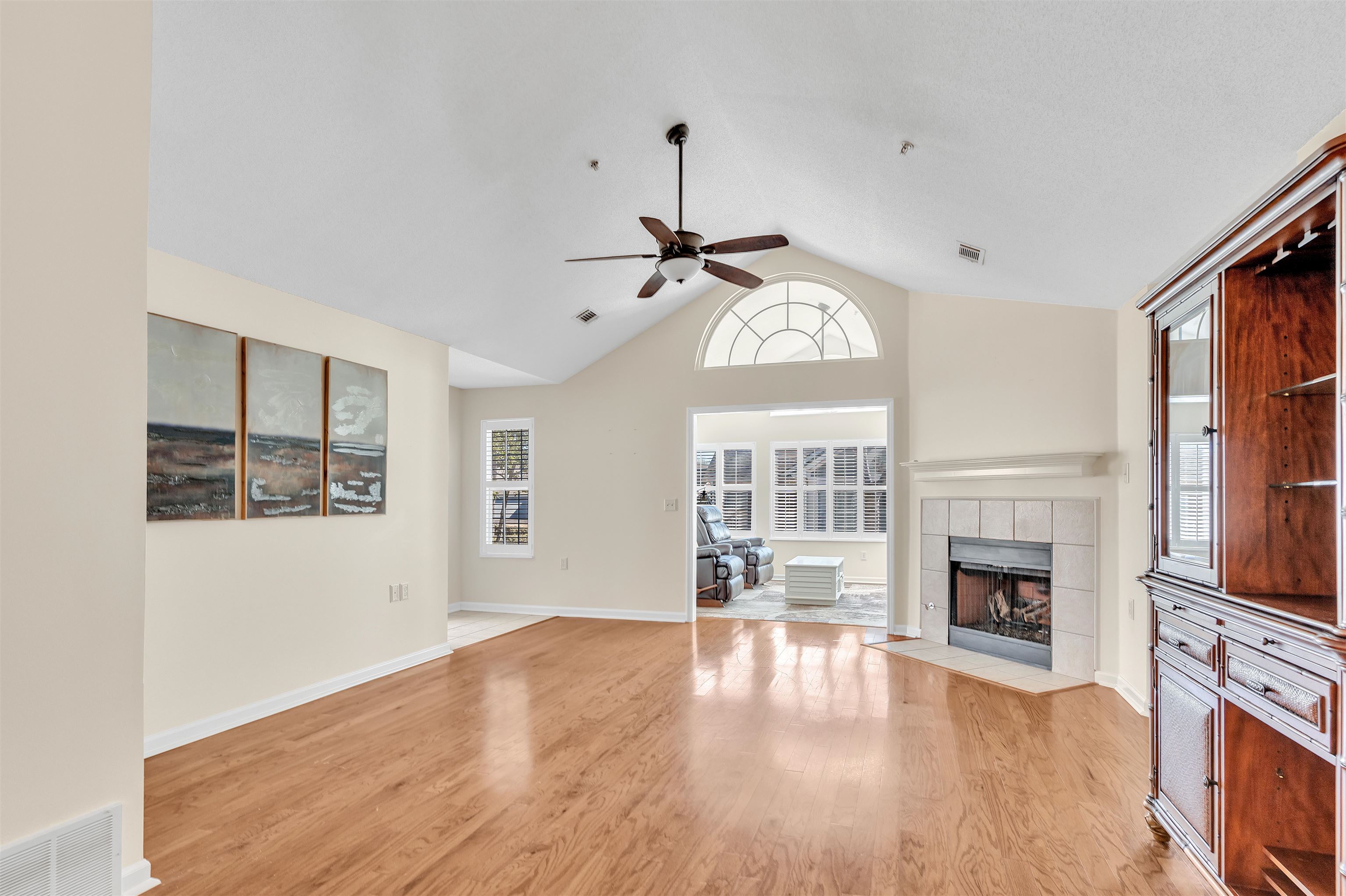 1213 Oak Timber Circle, Unit 25 Collierville, TN 38017 - Photo 18 of 25 Unfurnished living room with vaulted ceiling, light wood finished floors, a fireplace, and visible vents