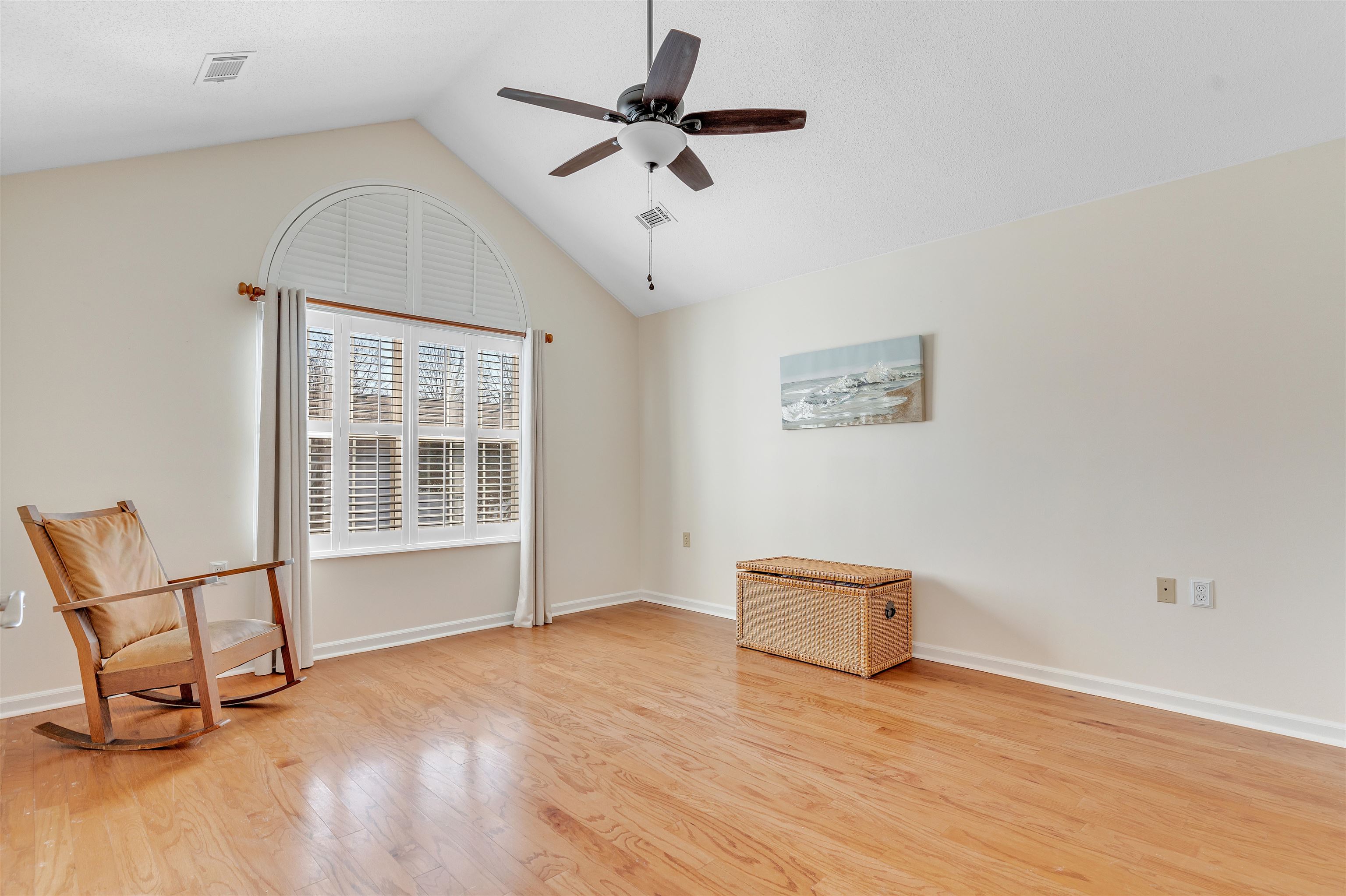 1213 Oak Timber Circle, Unit 25 Collierville, TN 38017 - Photo 19 of 25 Unfurnished room featuring visible vents, lofted ceiling, a ceiling fan, and light wood-style floors