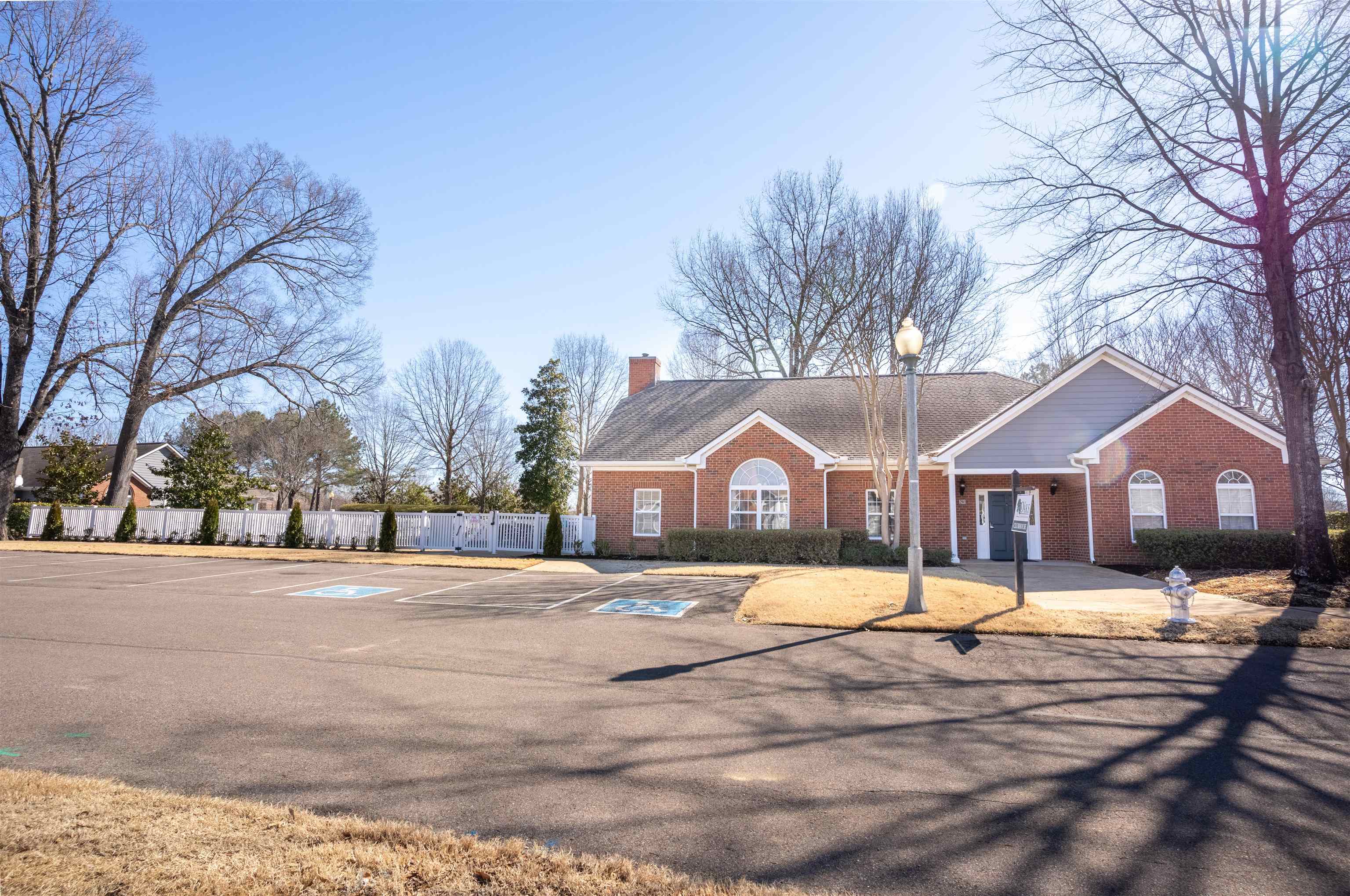 1213 Oak Timber Circle, Unit 25 Collierville, TN 38017 - Photo 25 of 25 Ranch-style house featuring uncovered parking, brick siding, a chimney, and fence