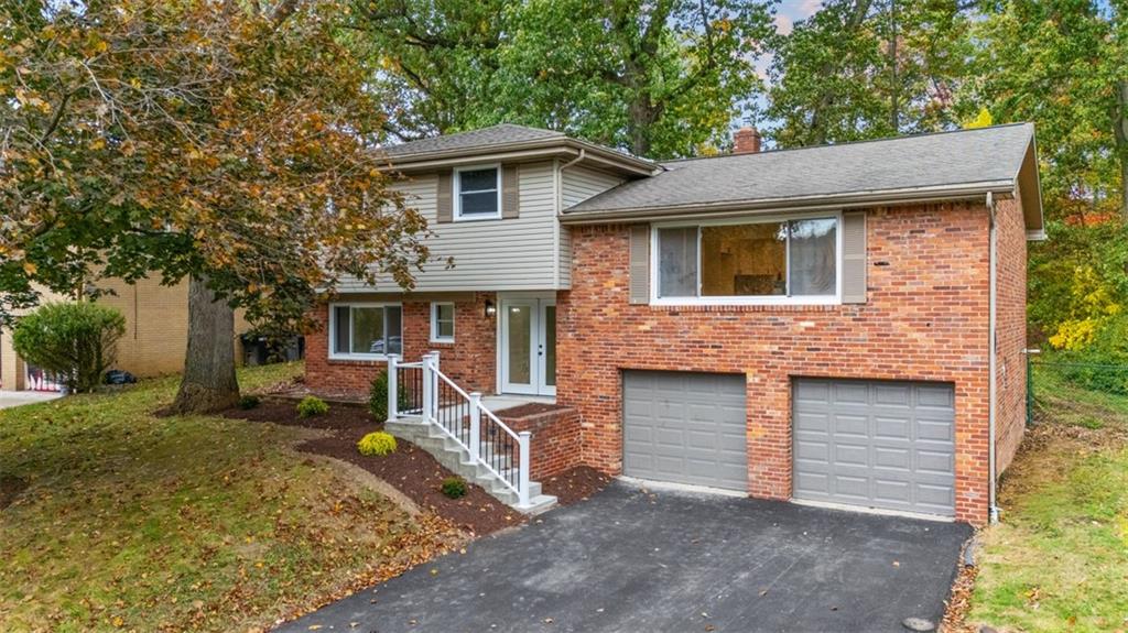 a front view of a house with a yard and garage