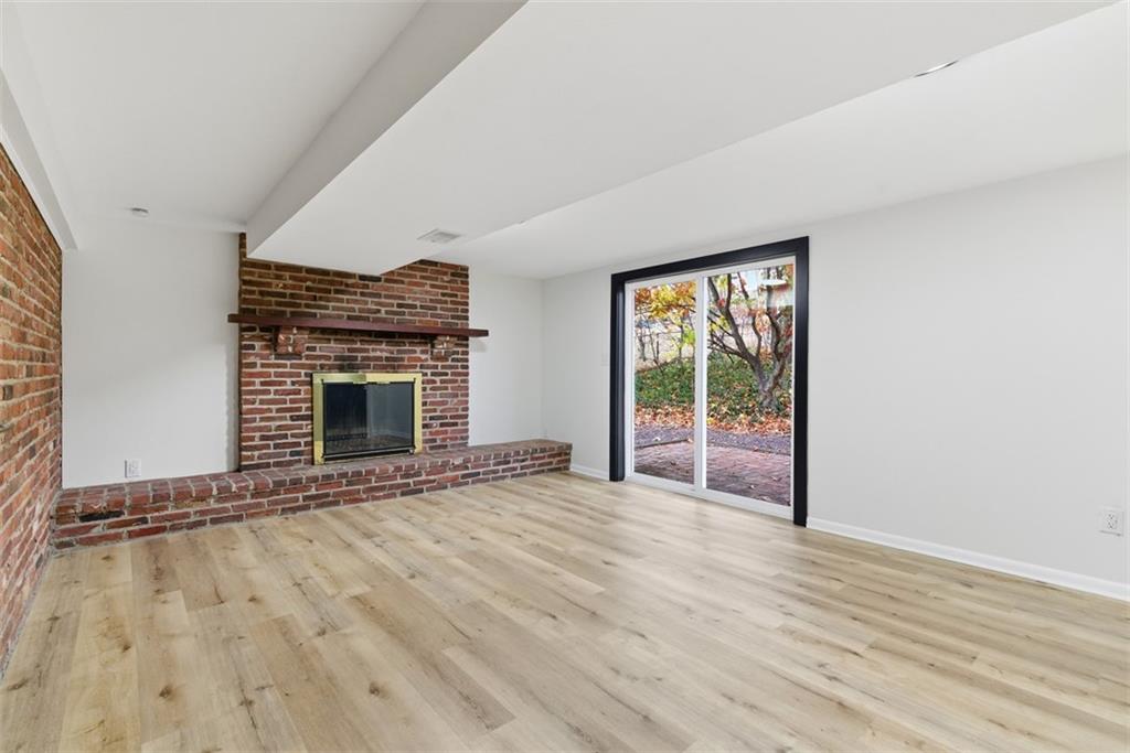 125 South Jamestown Road Coraopolis, PA 15108 - Photo 35 of 44 an empty room with wooden floor fireplace and windows
