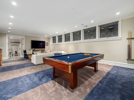 a living room with pool table and a flat screen tv