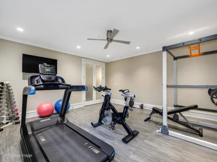 a room with gym equipment and windows