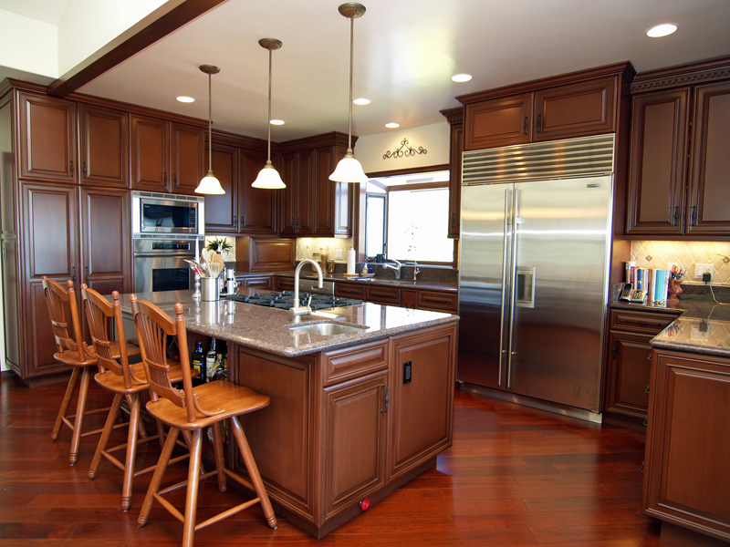 426 Las Alturas Road Santa Barbara, CA 93103 - Photo 1 of 7 a kitchen with stainless steel appliances kitchen island granite countertop a table chairs and a refrigerator