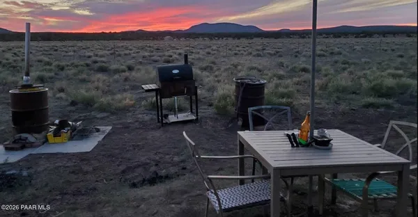 a view of a terrace with a table and chairs