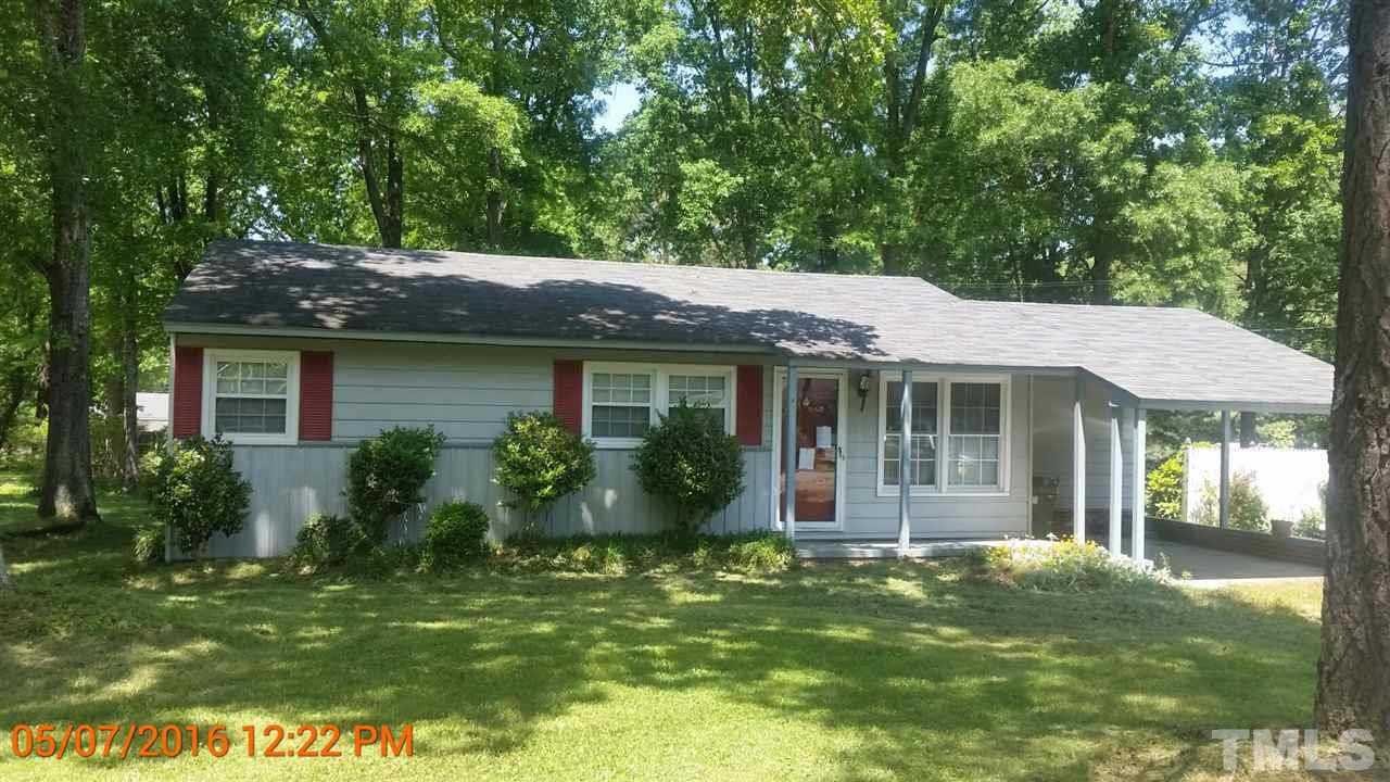 911 Frank Street Roxboro, NC 27573 - Photo 1 of 7 a front view of house with a garden