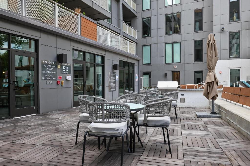 775 Juniper Street Northeast, Unit 602 Atlanta, GA 30308 - Photo 34 of 40 a view of a building with a table and chairs