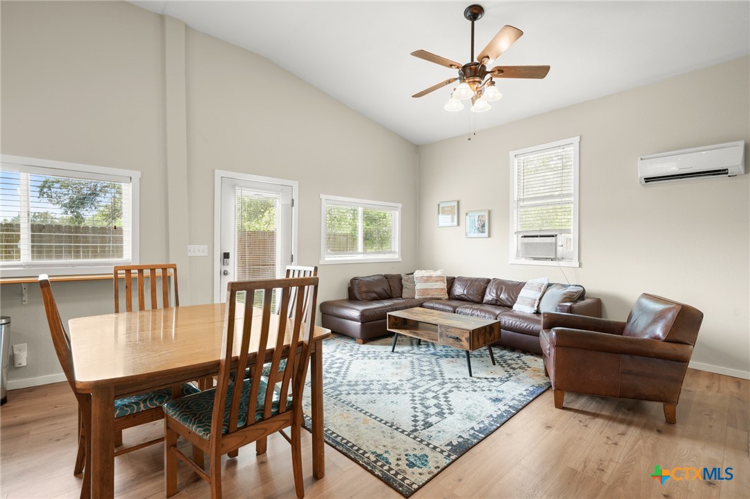 9725 Bock Road Buda, TX 78610 - Photo 31 of 37 Natural light bathes this comfortable living area, boasting vaulted ceilings and durable hardwood flooring.