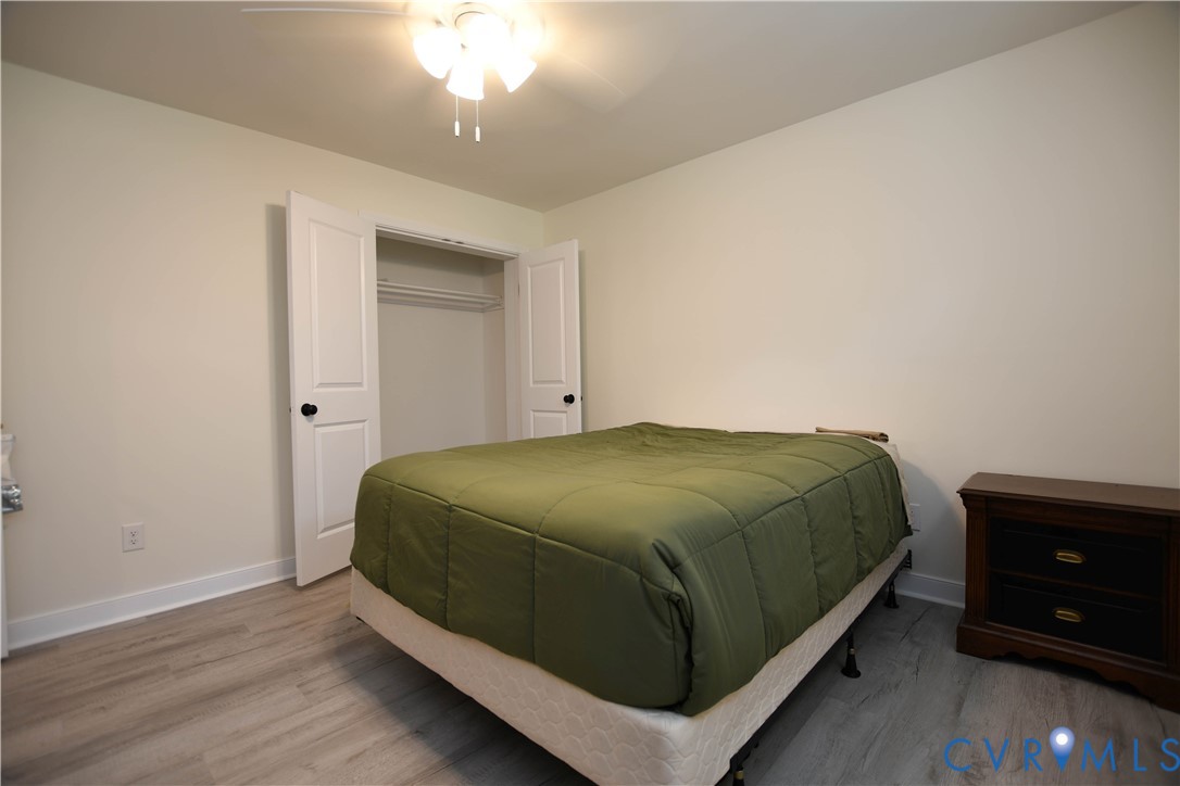 1448 Canterbury Road St. Stephens Church, VA 23148 - Photo 29 of 57 Neutral tone walls with white trim, wood-finish fl