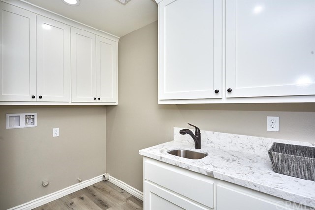 22227 Skyline Drive Apple Valley, CA 92308 - Photo 16 of 34 a kitchen with granite countertop white cabinets and sink