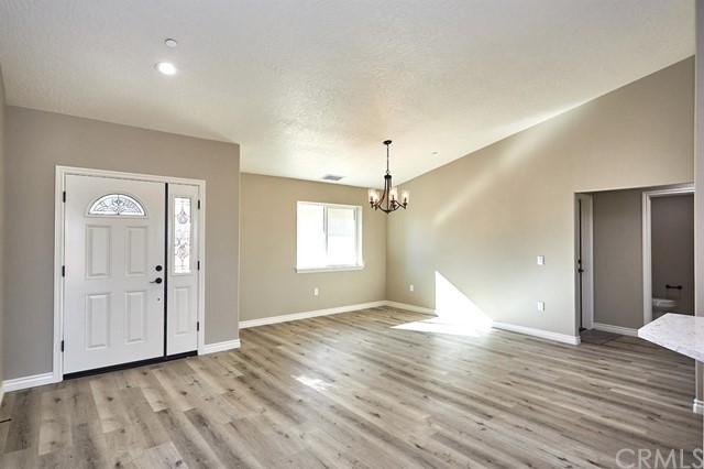 22227 Skyline Drive Apple Valley, CA 92308 - Photo 3 of 34 an empty room with wooden floor and windows