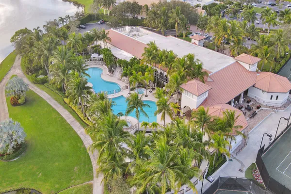 an aerial view of residential houses with outdoor space and street view
