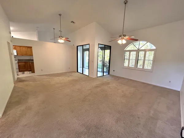 a view of a room with windows and chandelier