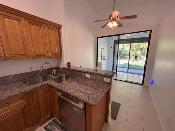 a kitchen with stainless steel appliances granite countertop a sink a stove and a microwave