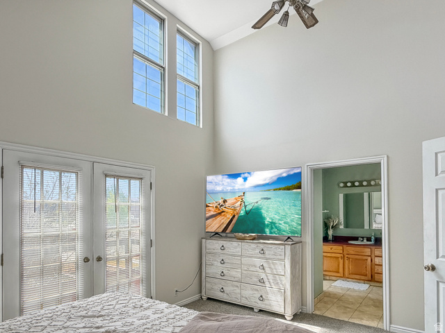 1716 Sagewood Road Price, UT 84501 - Photo 26 of 73 Bedroom with french doors, a high ceiling, ensuite bathroom, access to outside, and light colored carpet