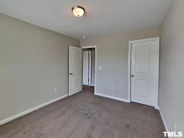 an empty room with closet area
