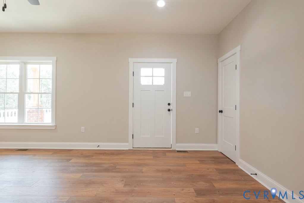 5200 Three Chopt Road Louisa, VA 23093 - Photo 11 of 47 a view of an empty room with wooden floor and a window
