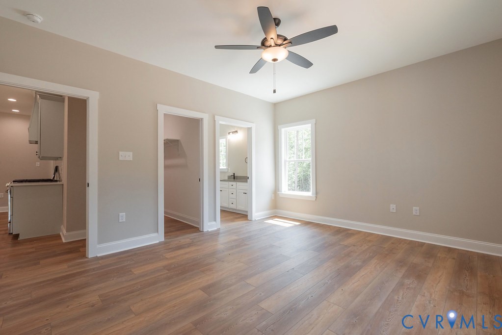 5200 Three Chopt Road Louisa, VA 23093 - Photo 19 of 47 an empty room with wooden floor and ceiling fan