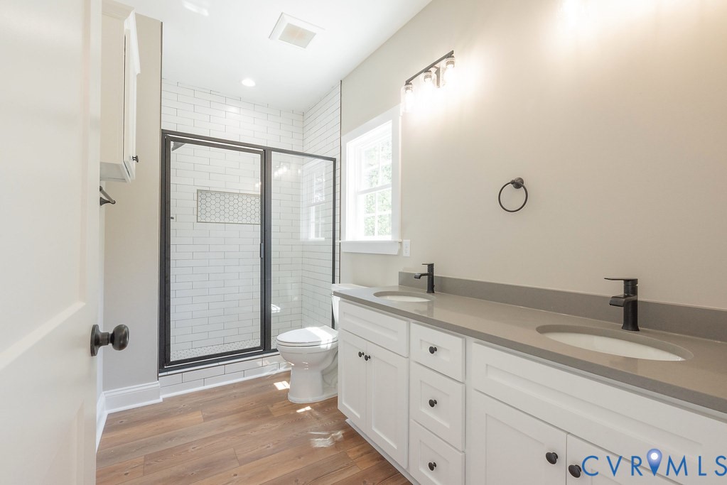 5200 Three Chopt Road Louisa, VA 23093 - Photo 23 of 47 a bathroom with a granite countertop sink a toilet and shower