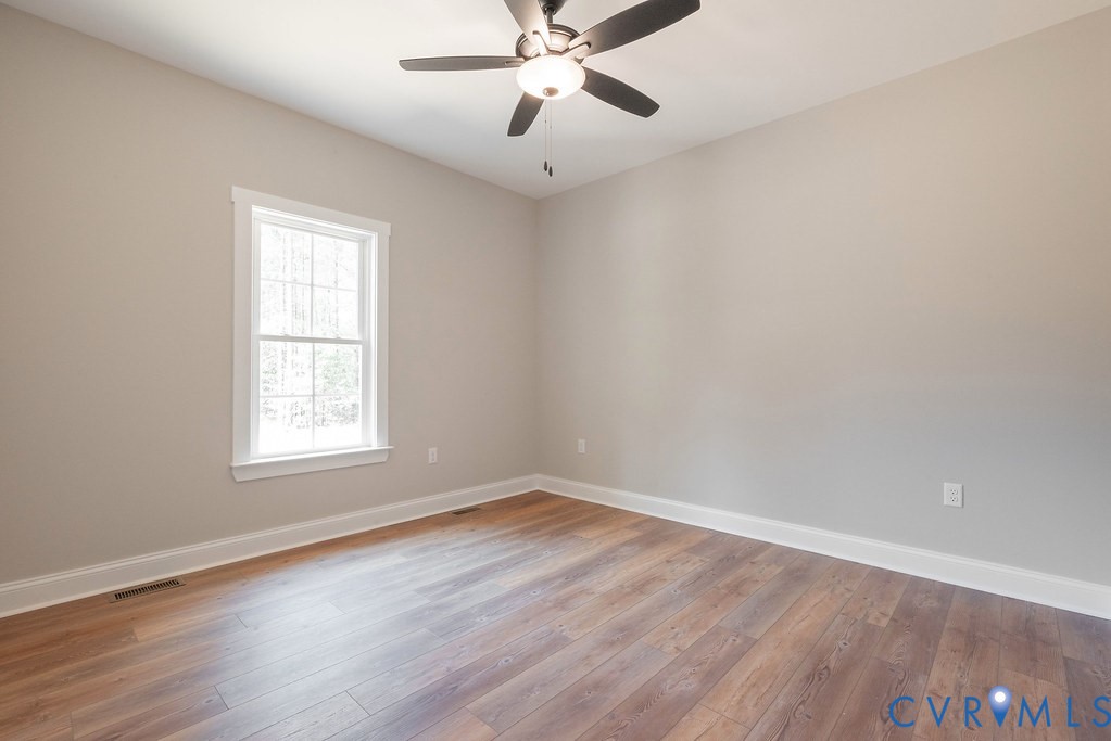 5200 Three Chopt Road Louisa, VA 23093 - Photo 24 of 47 wooden floor in an empty room with a window