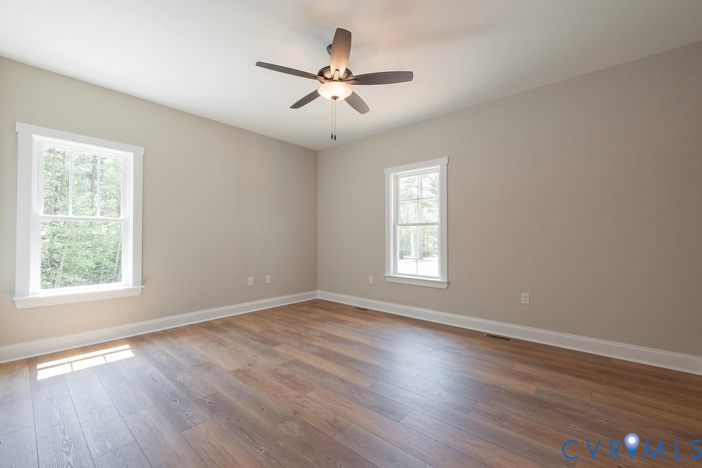 5200 Three Chopt Road Louisa, VA 23093 - Photo 26 of 47 wooden floor in an empty room with a window