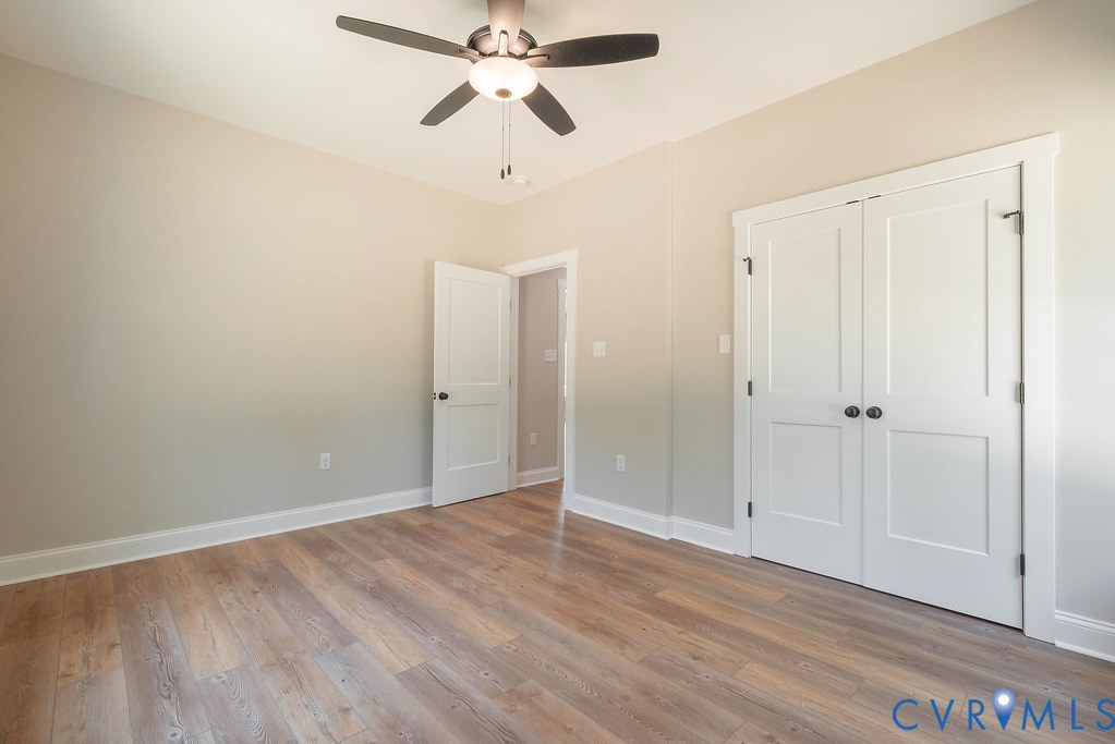 5200 Three Chopt Road Louisa, VA 23093 - Photo 27 of 47 an empty room with wooden floor closet and fan