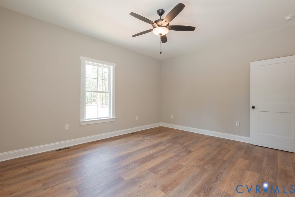 5200 Three Chopt Road Louisa, VA 23093 - Photo 29 of 47 an empty room with wooden floor and windows