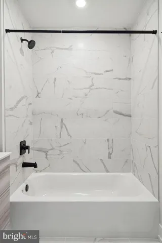 a bathroom with a shower and a bath tub
