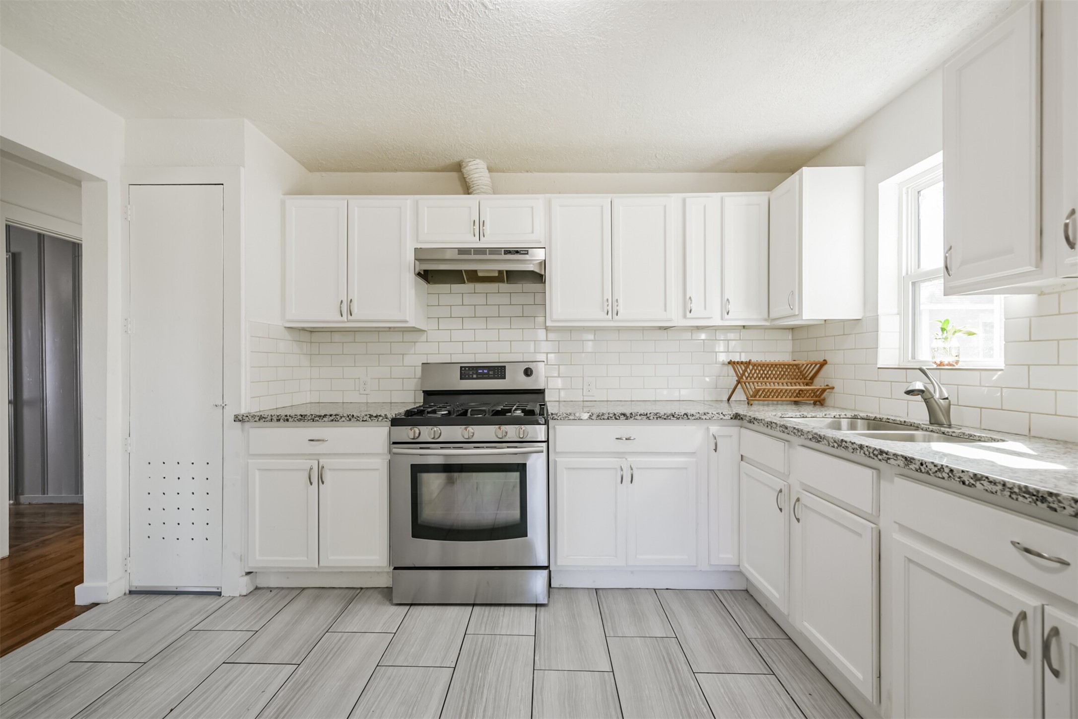 7546 Greendowns Street Houston, TX 77087 - Photo 1 of 33 a kitchen with stainless steel appliances granite countertop a stove a sink and a refrigerator