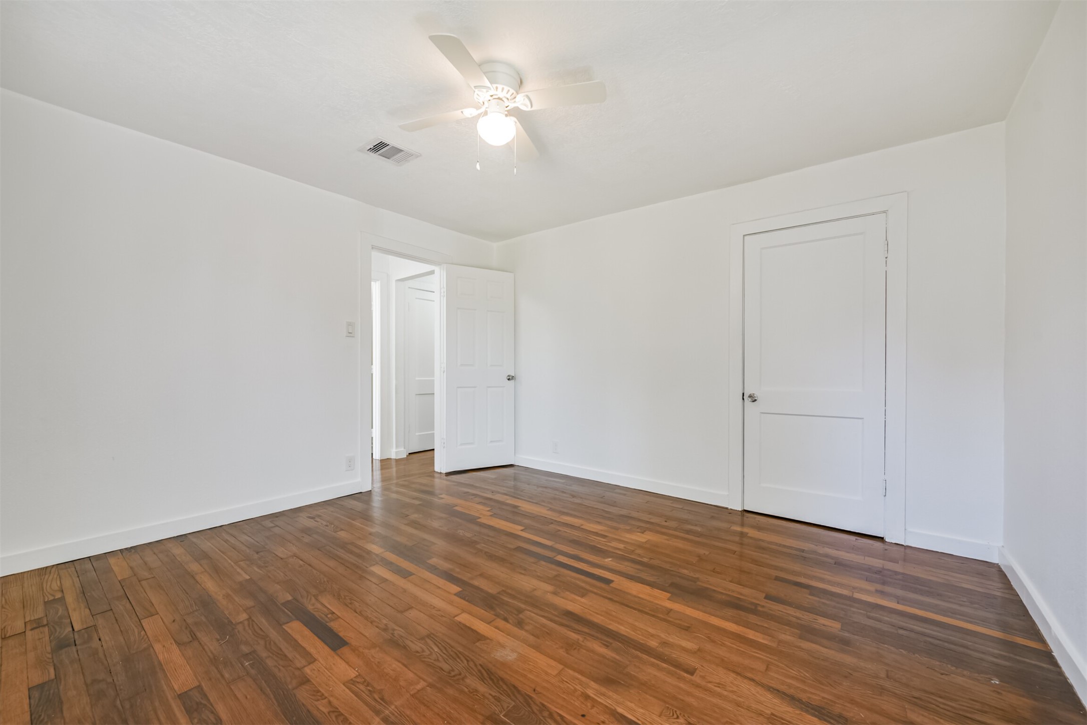7546 Greendowns Street Houston, TX 77087 - Photo 29 of 33 a view of an empty room with wooden floor
