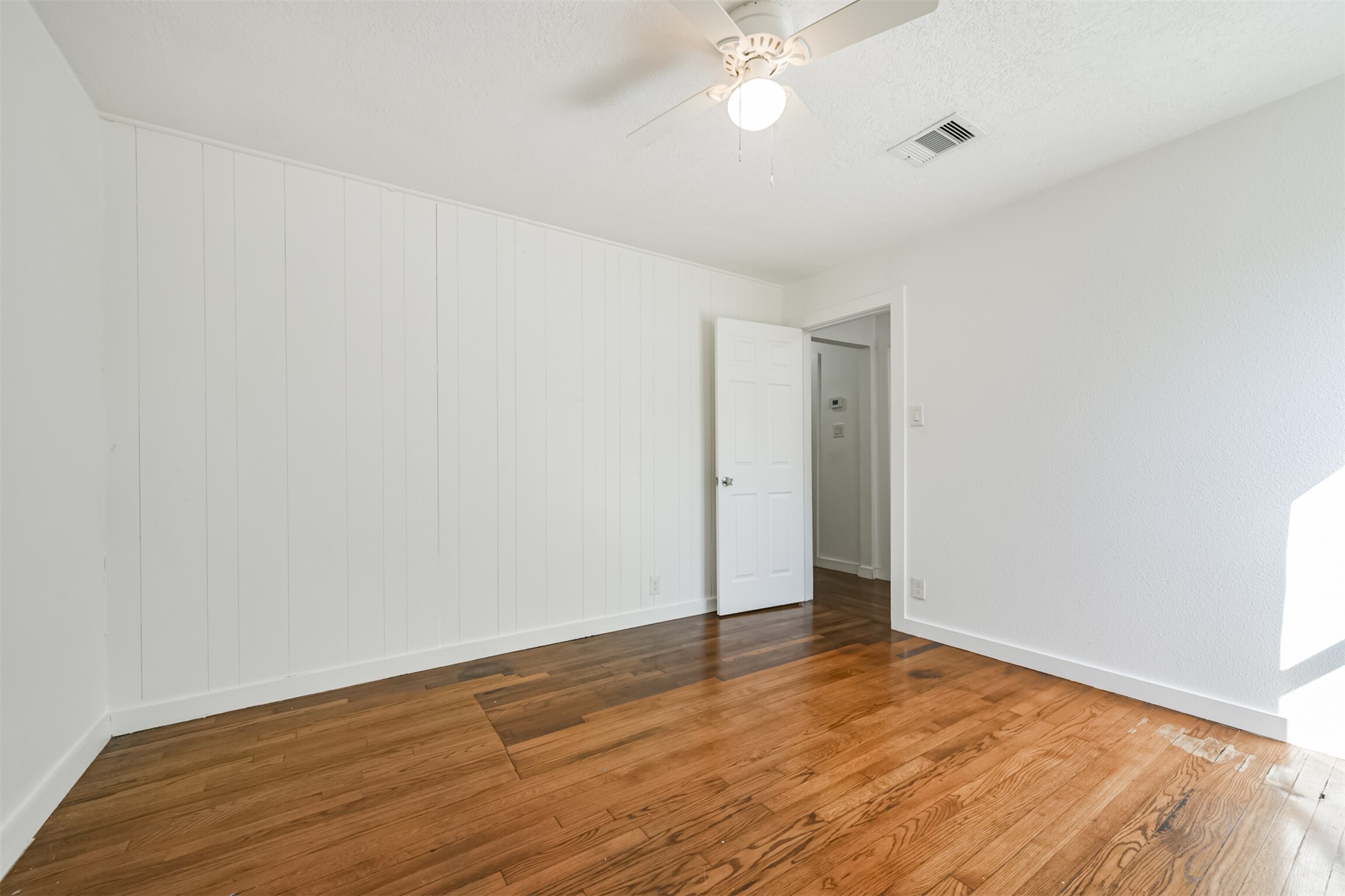 7546 Greendowns Street Houston, TX 77087 - Photo 31 of 33 a view of an empty room with wooden floor