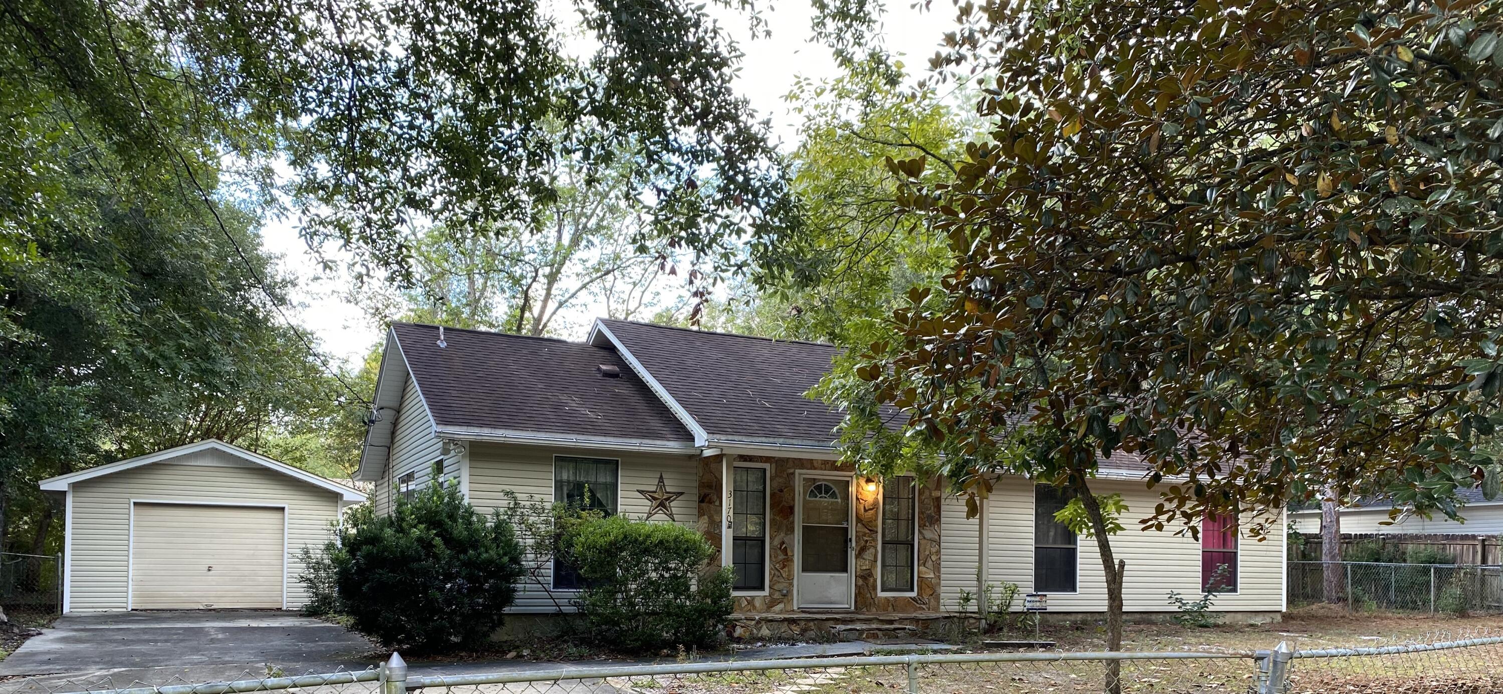 a house that has a tree in front of it