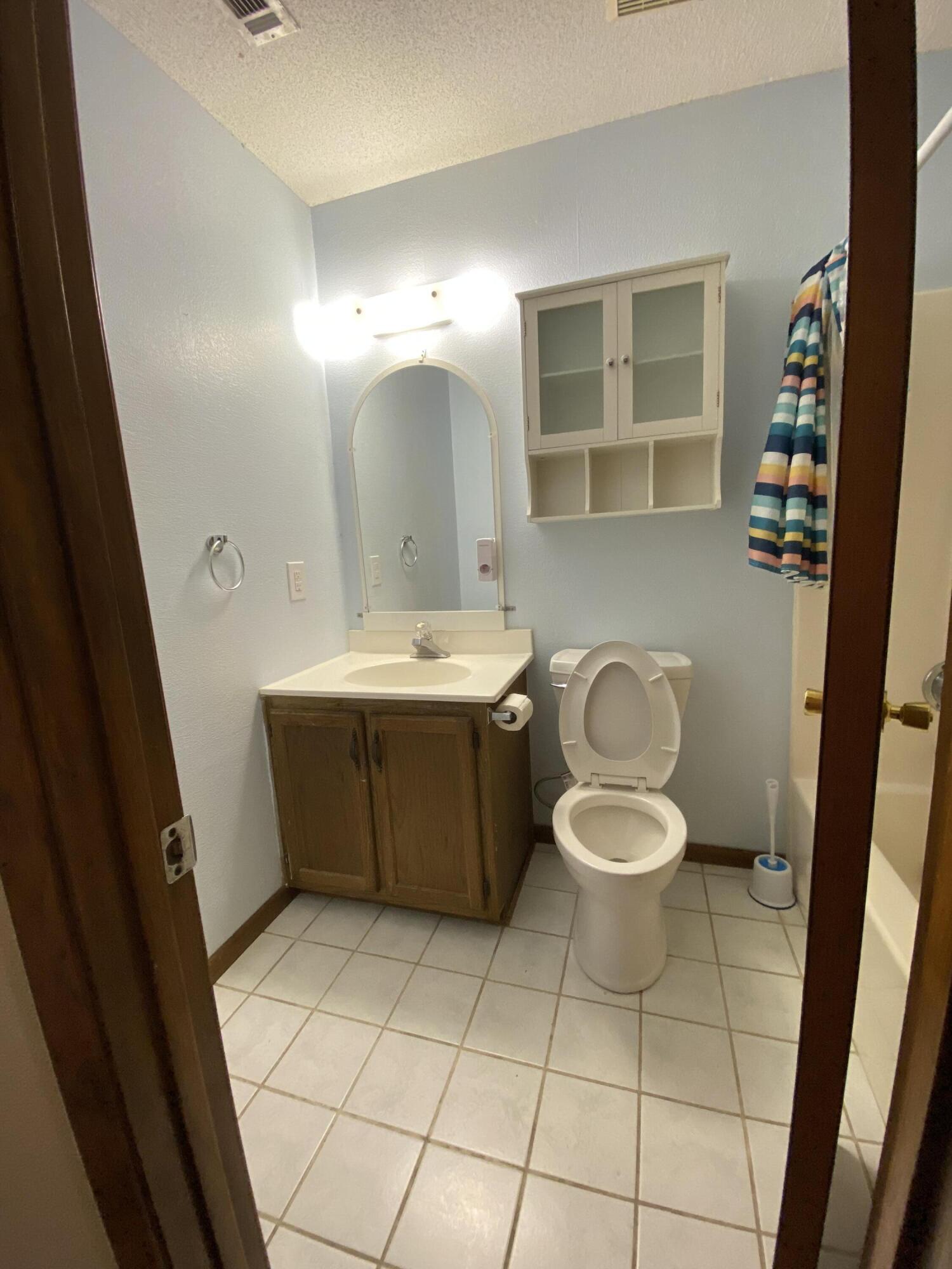 3170 Skyline Drive Crestview, FL 32539 - Photo 11 of 16 a bathroom with a sink toilet and mirror