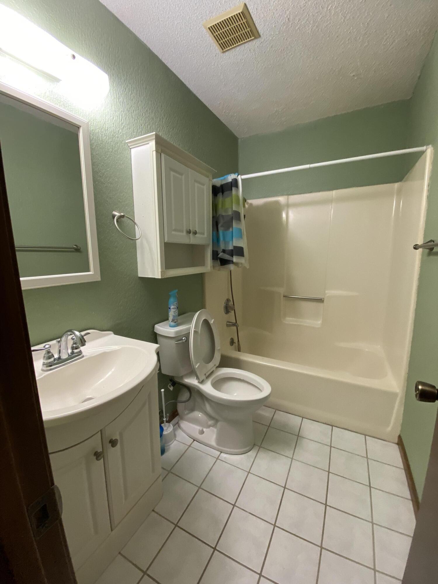 3170 Skyline Drive Crestview, FL 32539 - Photo 15 of 16 a bathroom with a sink toilet and shower