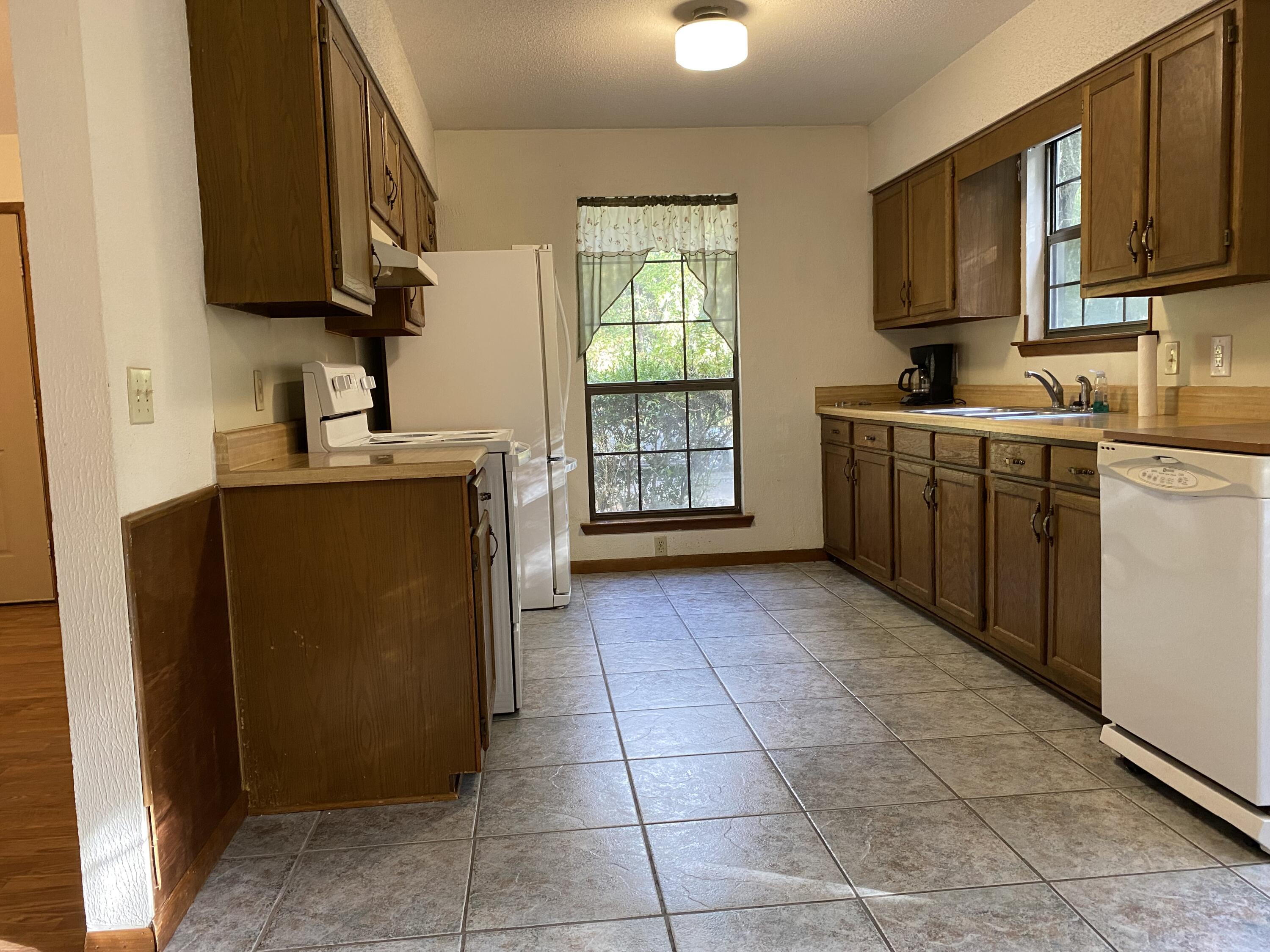 3170 Skyline Drive Crestview, FL 32539 - Photo 4 of 16 a kitchen with stainless steel appliances granite countertop a refrigerator stove and sink