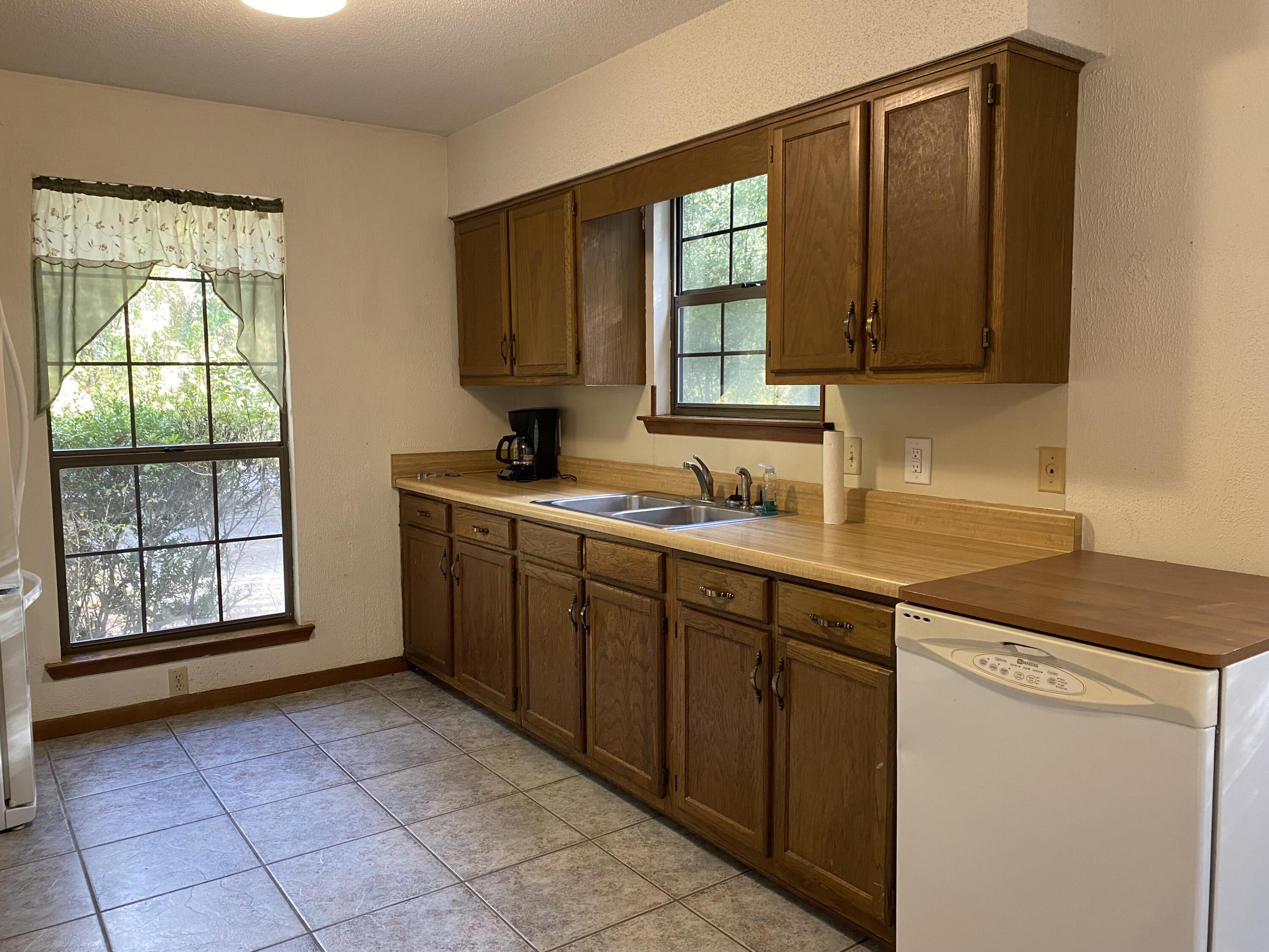 3170 Skyline Drive Crestview, FL 32539 - Photo 5 of 16 a kitchen with a sink window and cabinets