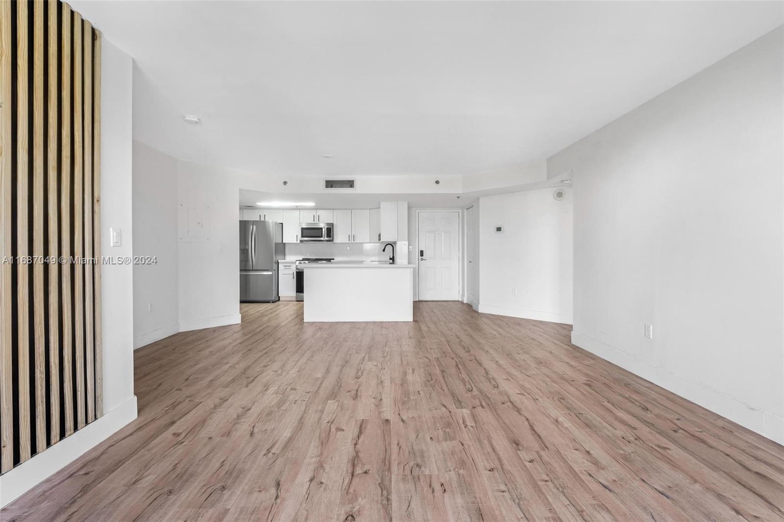 2351 Douglas Road, Unit 504 Miami, FL 33145 - Photo 11 of 41 a view of a kitchen with wooden floor and electronic appliances