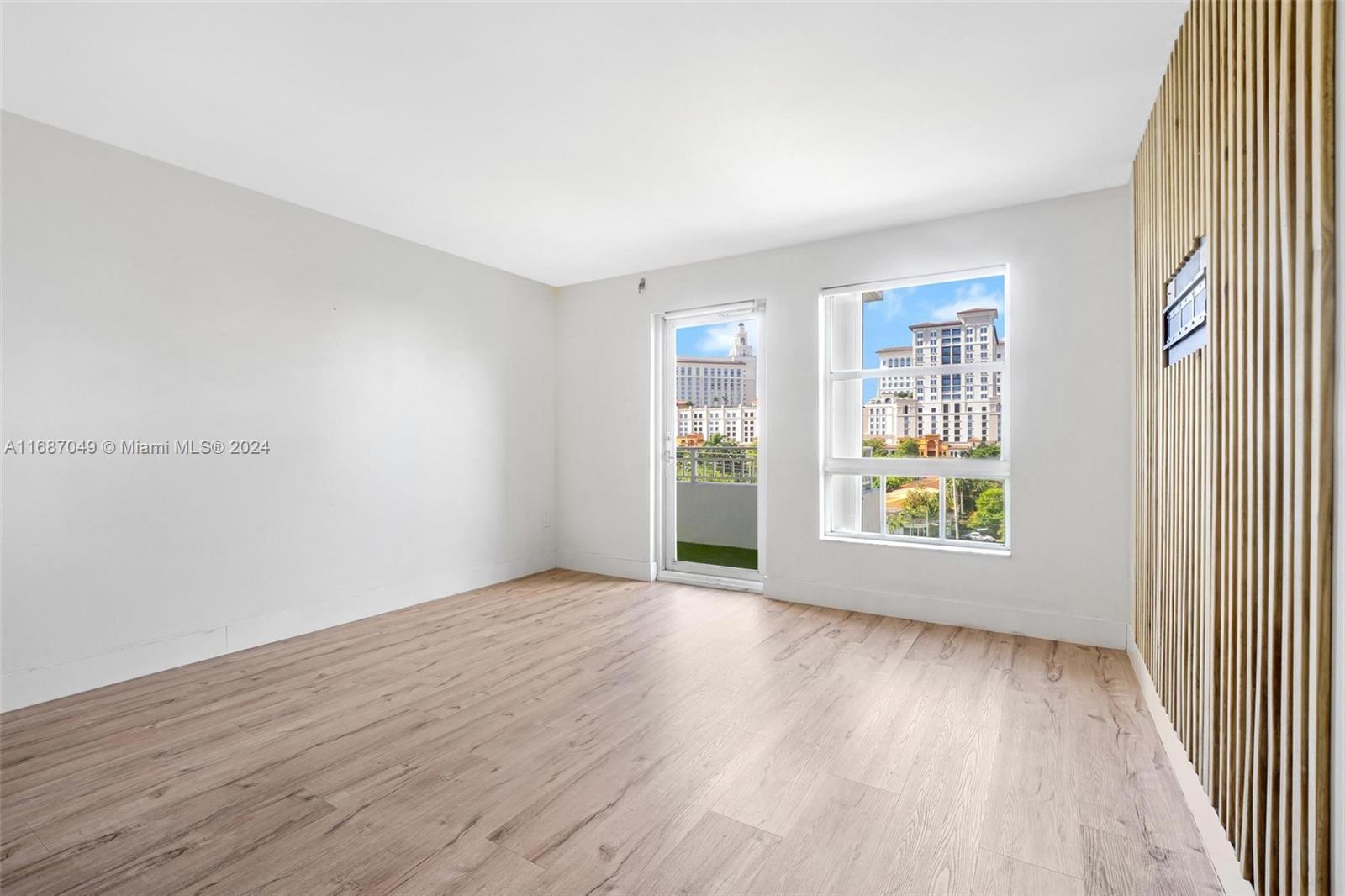 2351 Douglas Road, Unit 504 Miami, FL 33145 - Photo 14 of 41 an empty room with wooden floor and windows