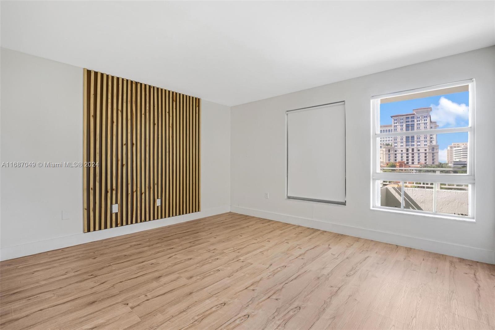 2351 Douglas Road, Unit 504 Miami, FL 33145 - Photo 15 of 41 a view of an empty room with wooden floor and a window